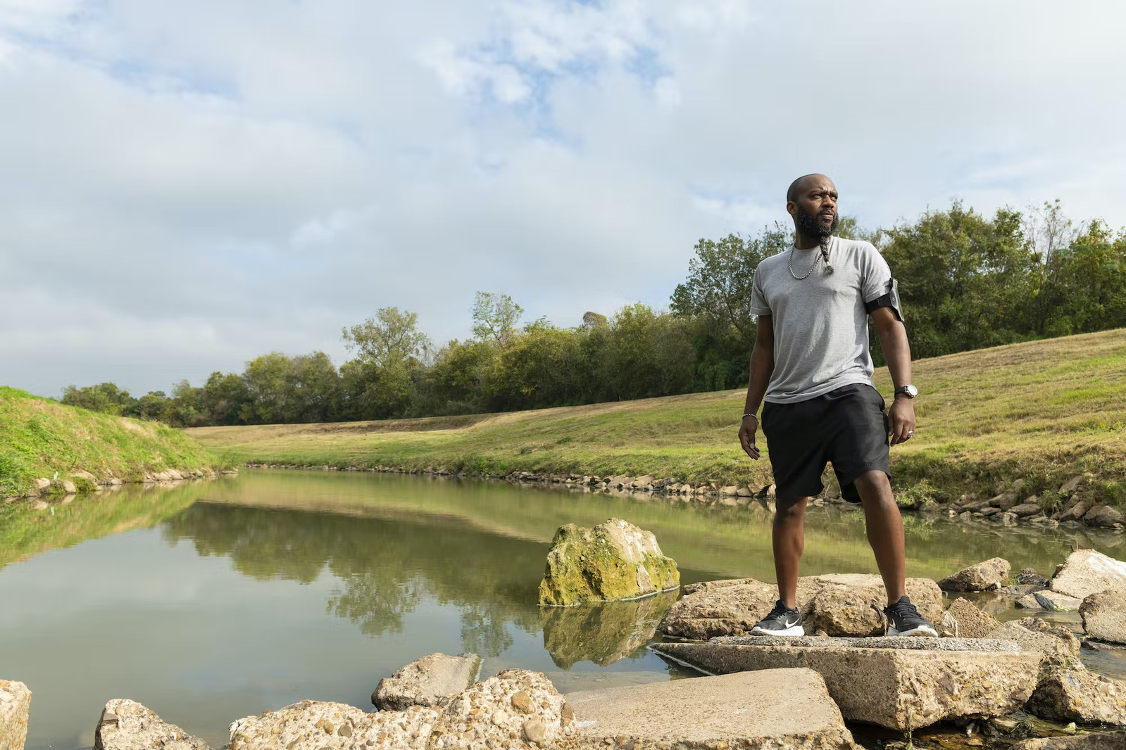 Man standing on a rock beside a lake